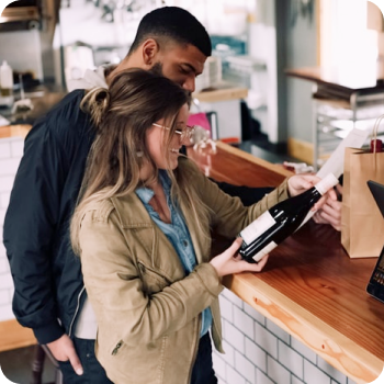 Loyal customers purchasing a bottle of wine from a liquor store